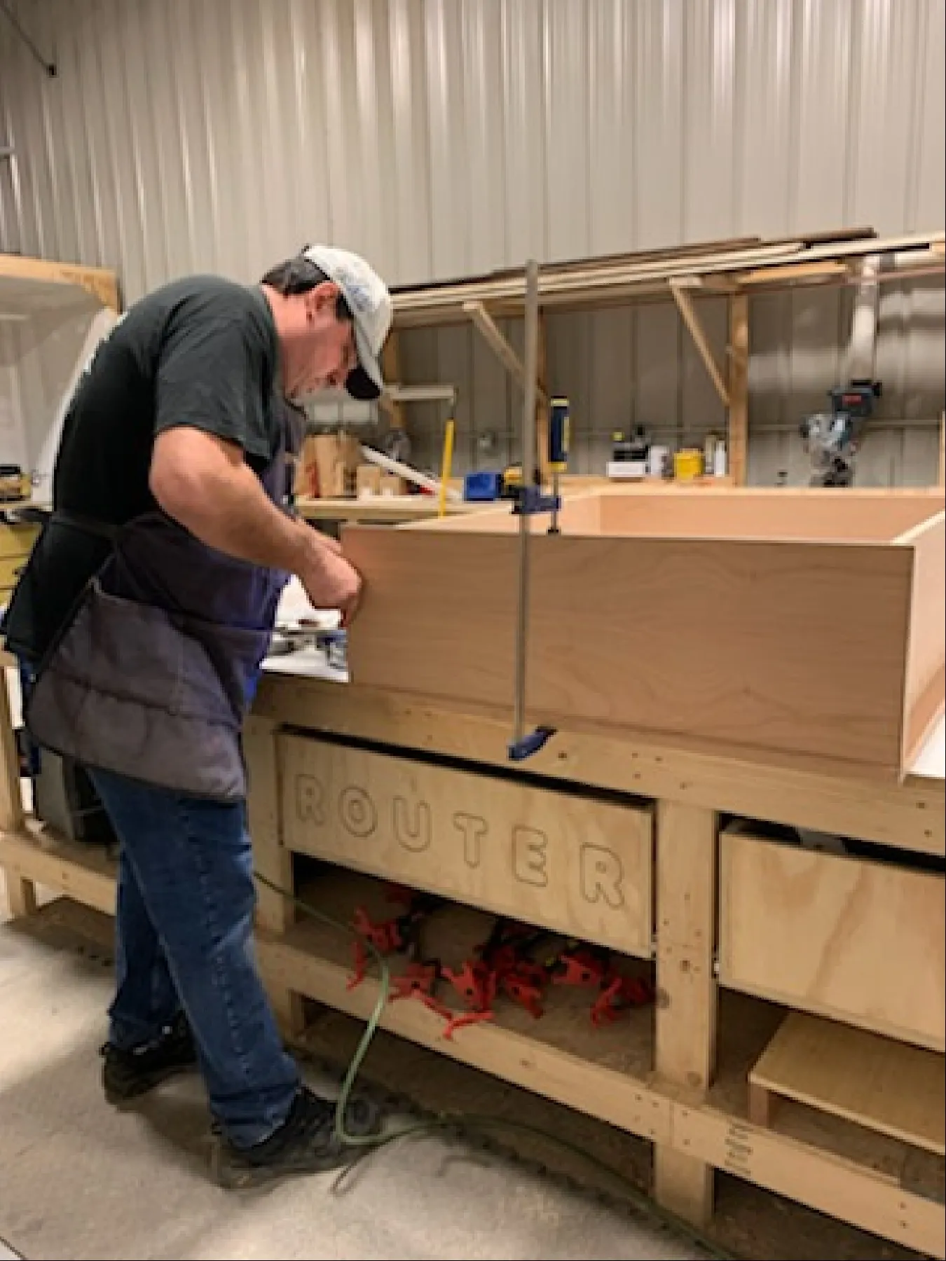 Craftsman assembling a cabinet at the router station